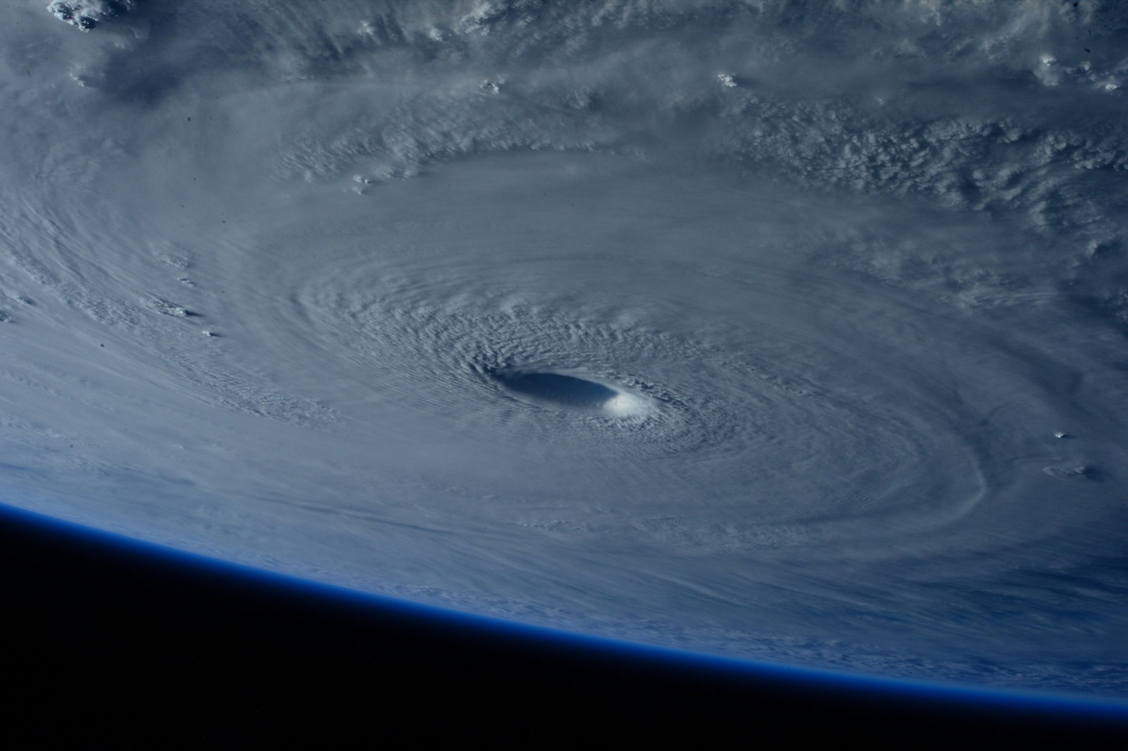 Hurricane seen from orbit with its eye visible through the clouds